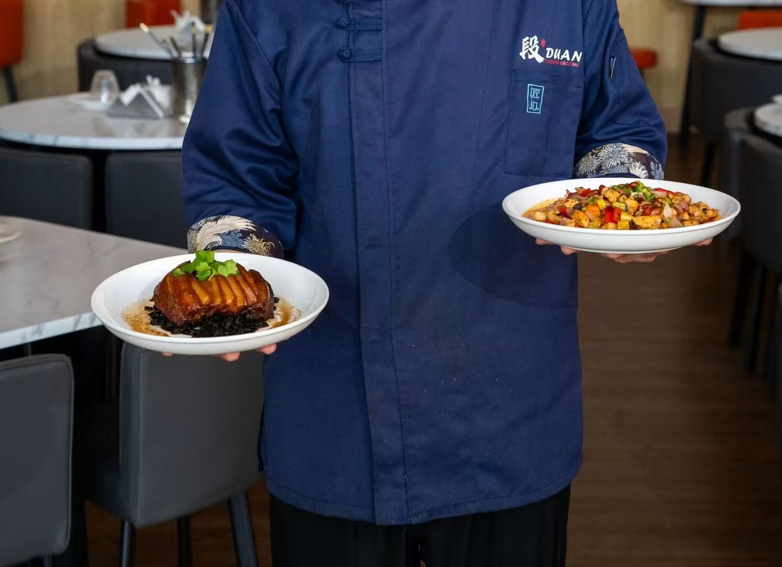 Braised pork belly and a colorful stir-fry plated and ready to serve