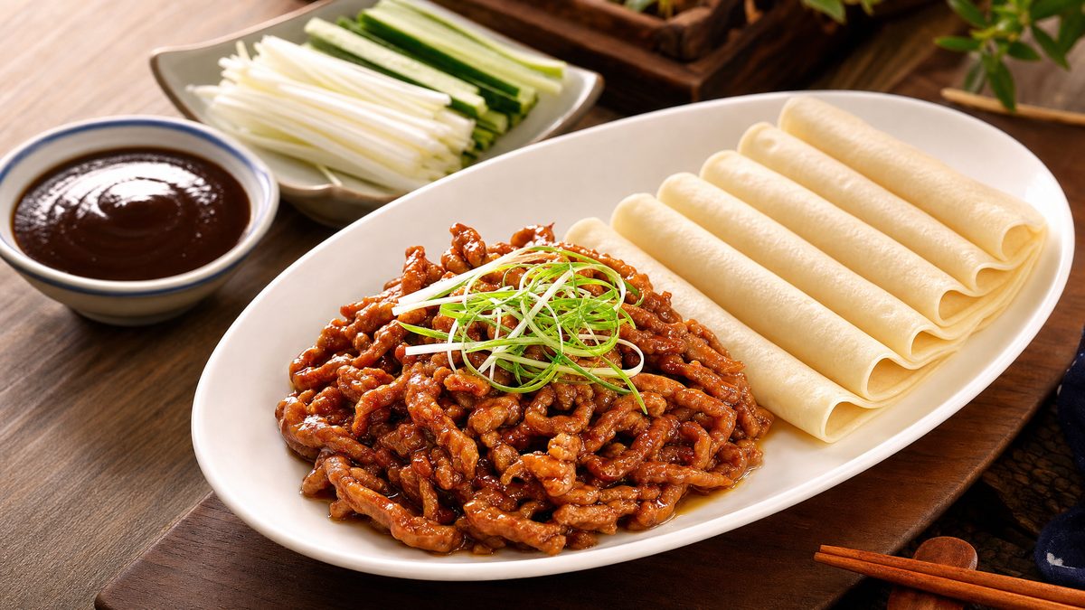 Peking shredded chicken in sweet bean sauce with thin pancakes, cucumber and scallion