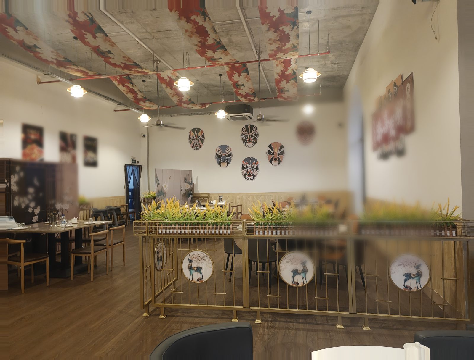 Dining room with gold railings and fabric ceiling banners