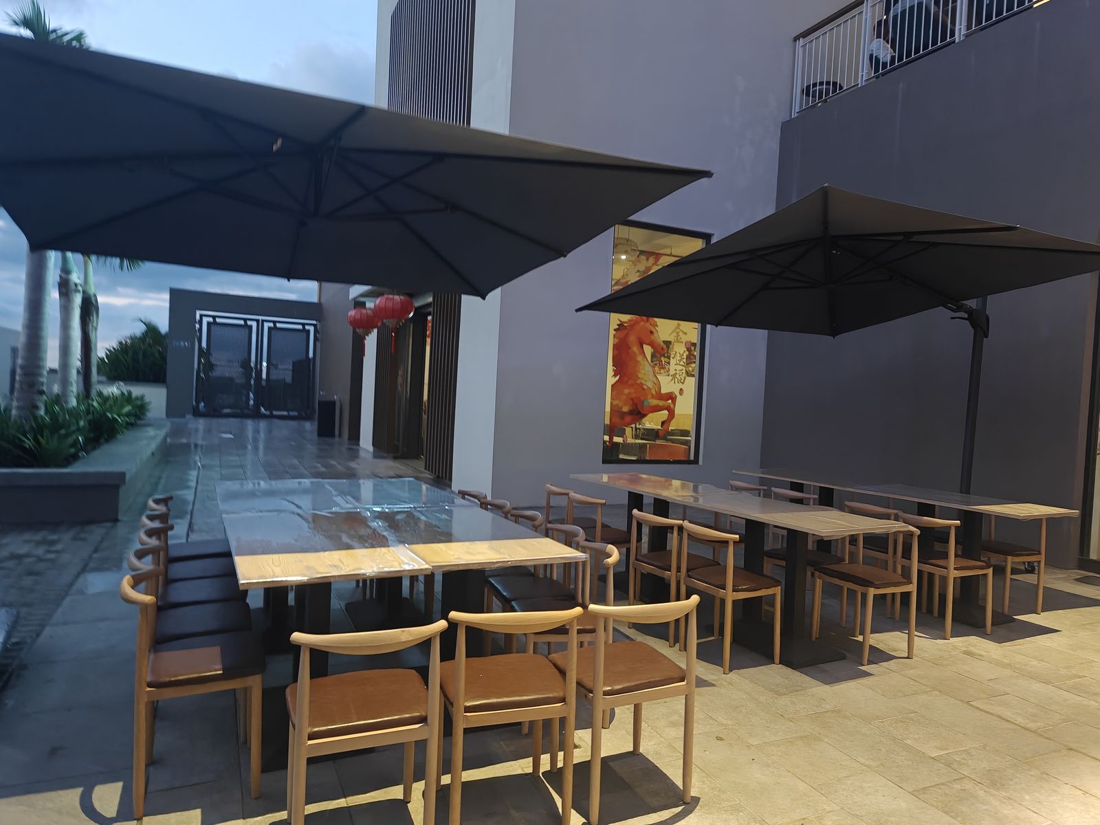 Covered terrace seating at dusk